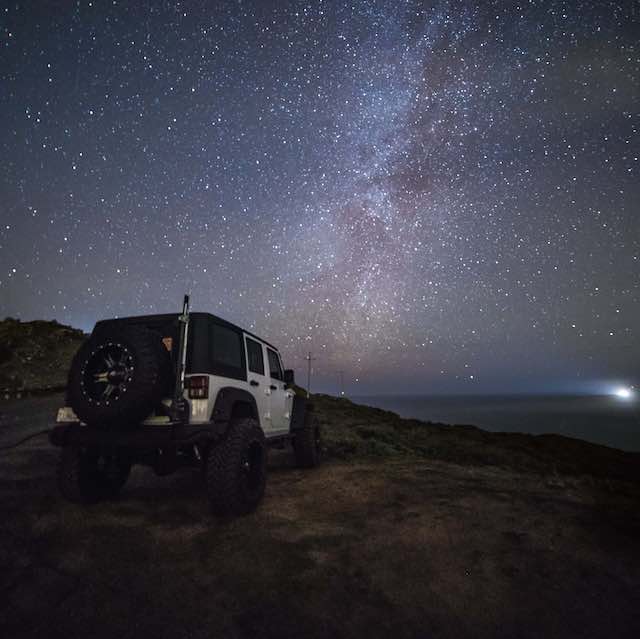 White Jeep Wrangler on a starry night